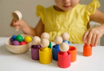 Preschooler with wooden toys