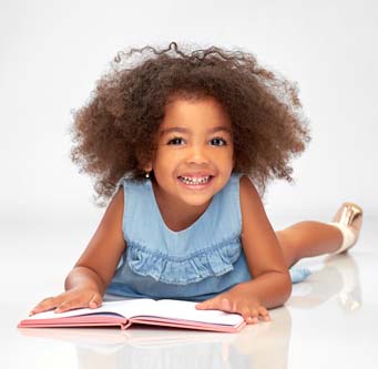 happy little girl with a book