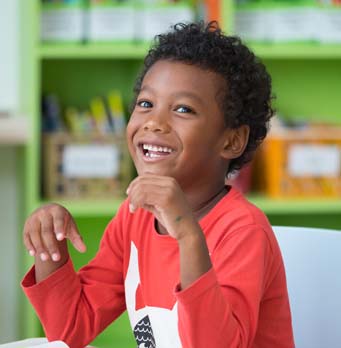 happy little boy in a classroom