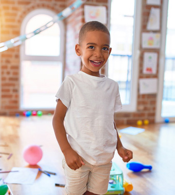 smiling little boy with toys